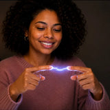 A person observing the subtle shimmering energy surrounding their hands while practicing a Reiki aura exercise in a dimly lit room.