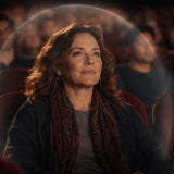 Highly intuitive woman using energetic protection while sitting in a crowded movie theater.